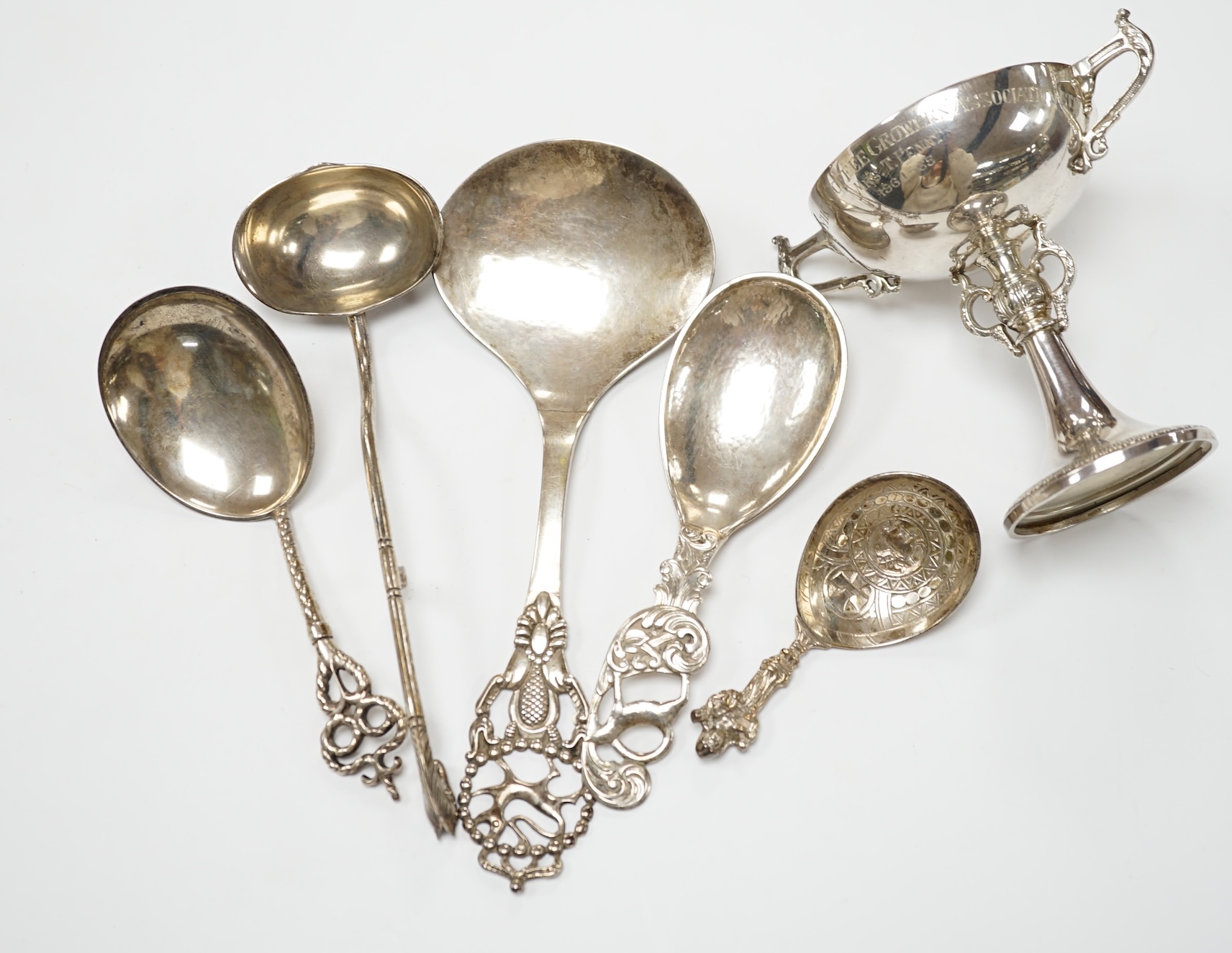 Five assorted early to mid 20th century Danish 830S spoons, largest 21.1cm, together with an Elizabeth II silver two handled presentation trophy cup with engraved inscription relating to the 'Tanganyika Coffee Growers As